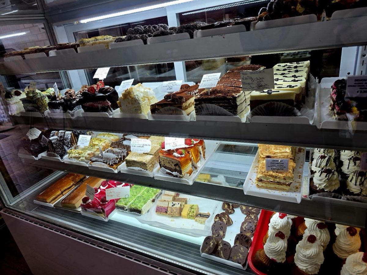 The cake and pastry counter at Delicio Patisserie, filled with freshly made continental slices, tiramisu, éclairs and custard pies